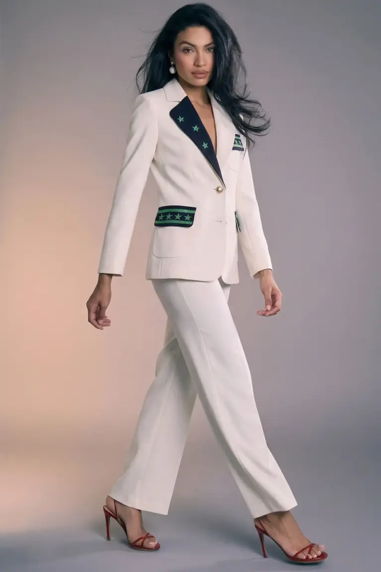 "La Julianne Blazer aporta una energía vibrante al tailoring clásico con un diseño audaz y contemporáneo. Confeccionada en un elegante azul marino, se realza con llamativos detalles en verde esmeralda que decoran las solapas, el bolsillo superior y las carteras, creando un contraste fresco y lleno de personalidad. Su silueta entallada y hombros estructurados estilizan la figura, mientras que los botones dorados añaden un toque sofisticado y luminoso. Los detalles gráficos con estrellas aportan un aire moderno y distintivo que convierte esta blazer en una pieza protagonista, perfecta para quienes buscan elegancia con carácter. Combínala con denim para un look relajado pero pulido, o con pantalones de sastrería para un estilismo más refinado. Versátil, poderosa y con un espíritu contemporáneo: una blazer diseñada para destacar en cualquier ocasión."